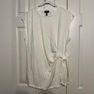 L solid white sleeveless t-shirt with decorative tie on side at waistline.